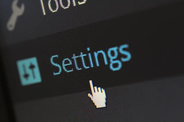 A close-up photo of a computer screen showing the settings button with a cursor hovering over it. Mapping old ticket statuses to a new Zendesk system